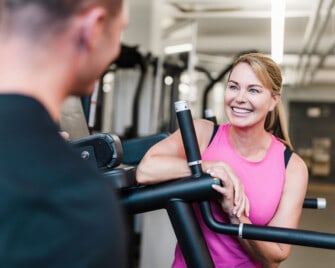 Woman talking to a personal trainer.
