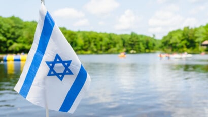 Israeli flag waving on the beach.
