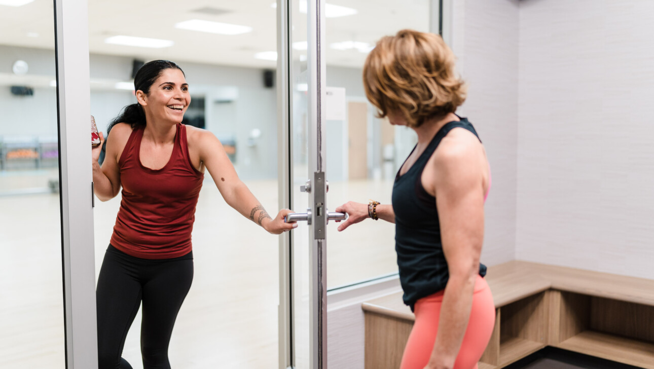 A woman greeting another person.