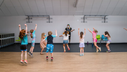 Kids dancing during a music class at camp.