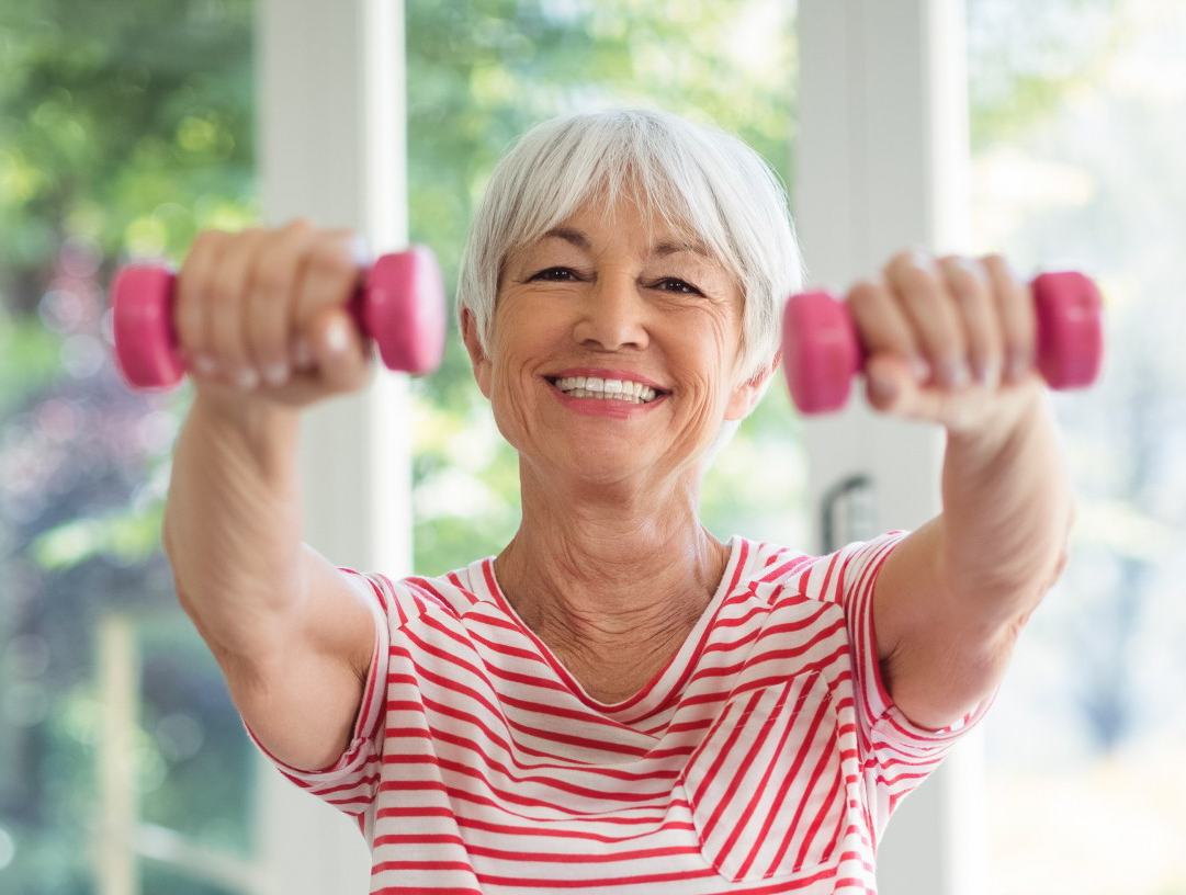 A woman exercising using dumbbells.