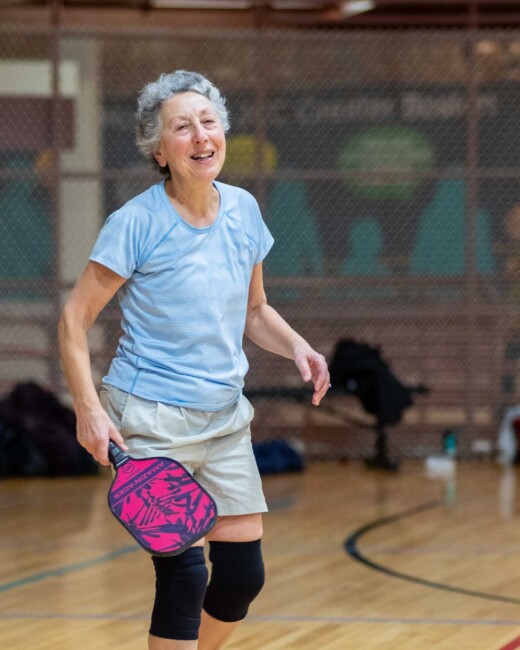 A woman playing pickleball.