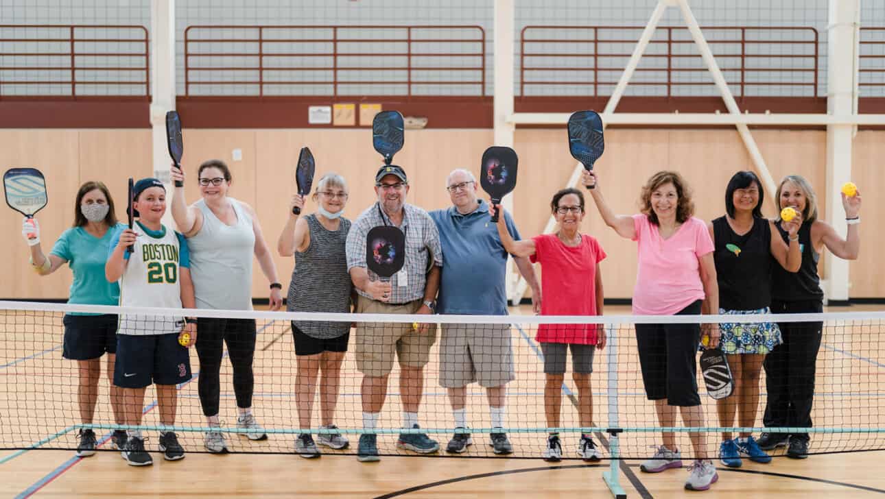 A group of people ready to play pickleball.