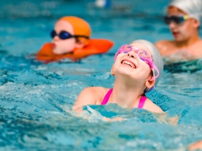 Girl swimming at the JCC Greater Boston indoor pool.
