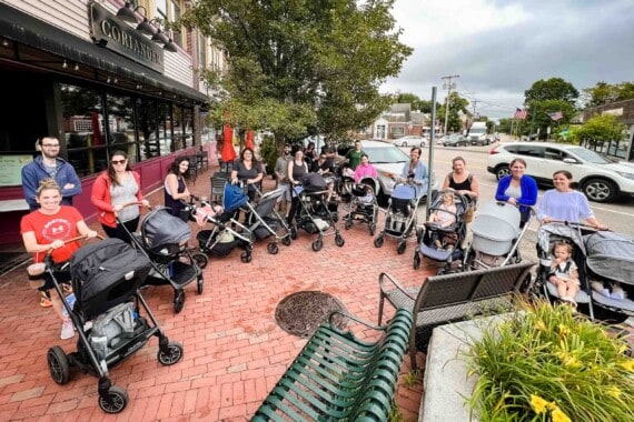 Group of parents on a stroller walk.