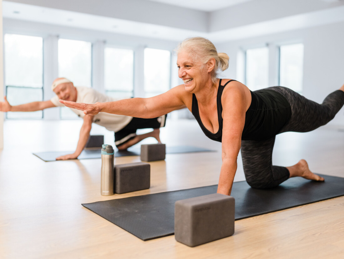 Two people practicing yoga.