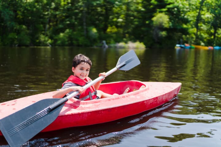 Boy smiling in a kayak.