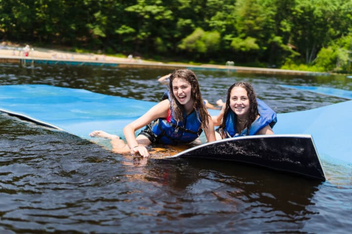 Girls on a water float at Camp Grossman.