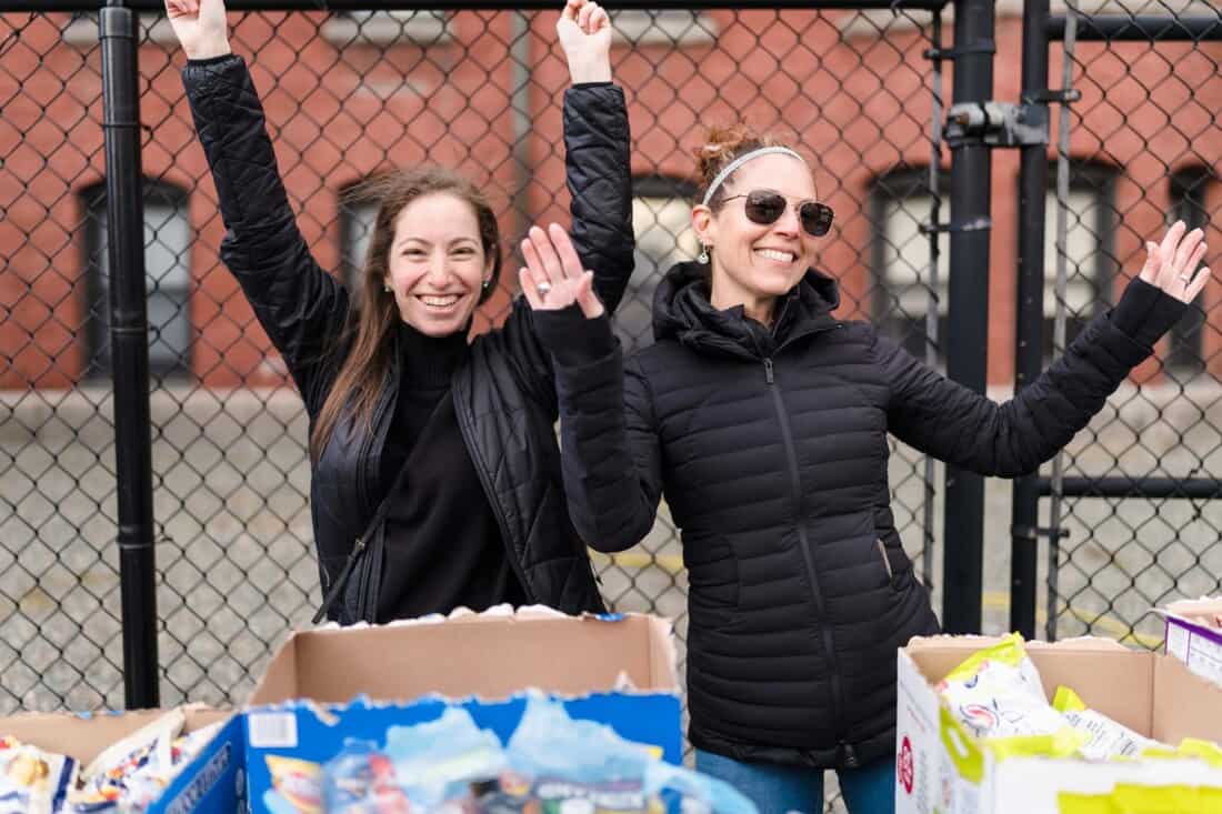 Staff members happily waving their hands in the air.