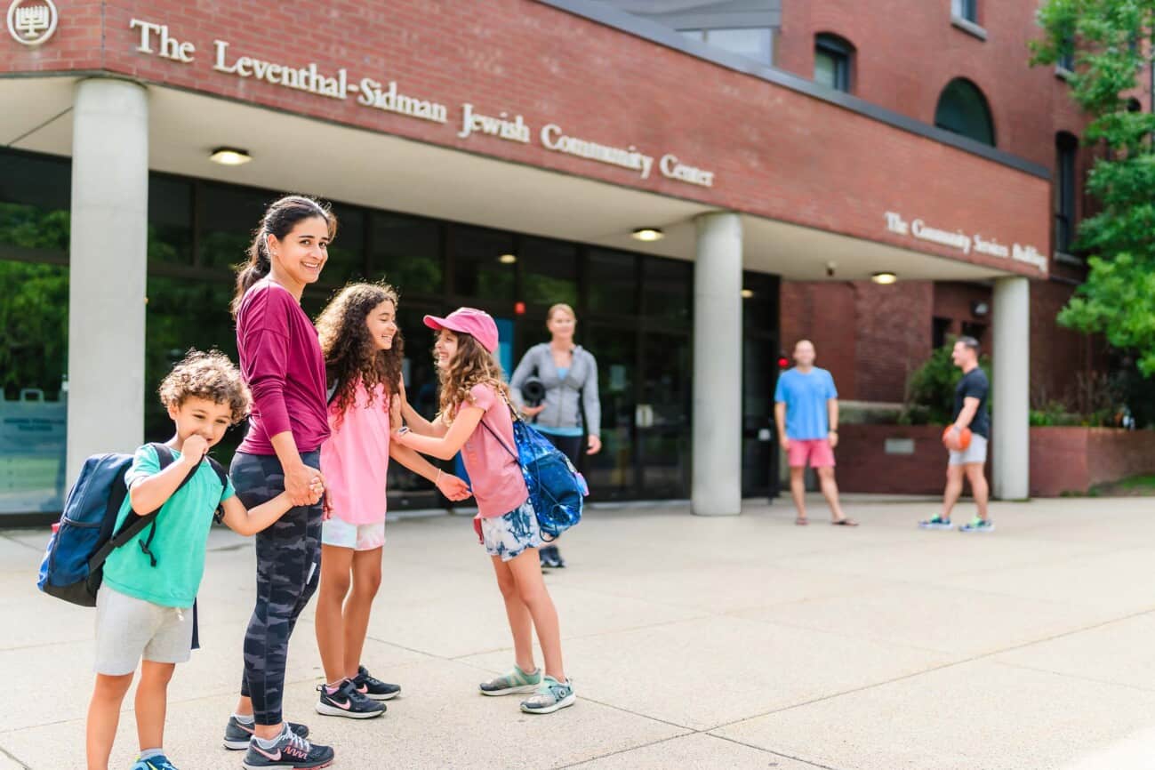 A family outside of the JCC Greater Boston building.