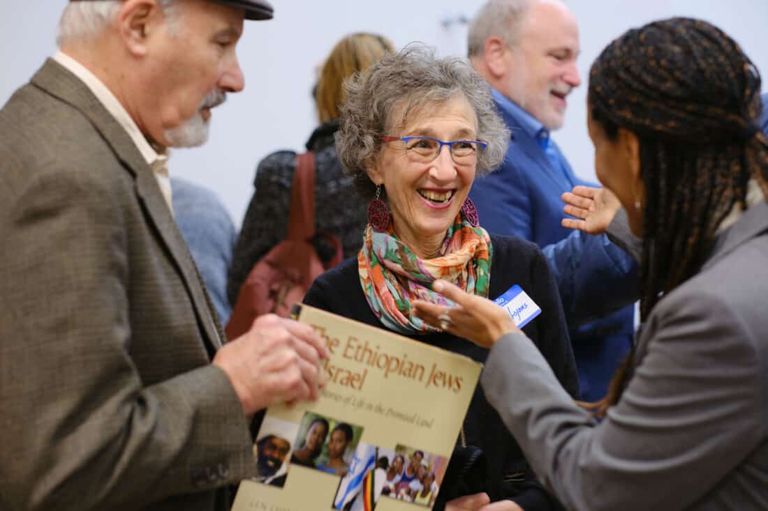 Couple holding a book and meeting the author.