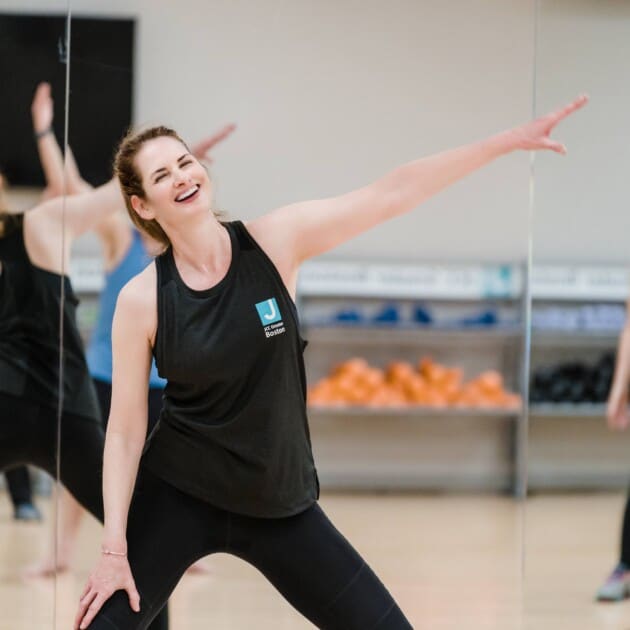 Instructor leading a dance fitness class.