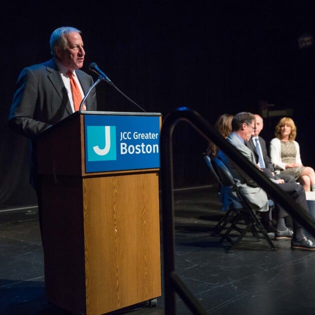 A man delivering a lecture at a discussion series.