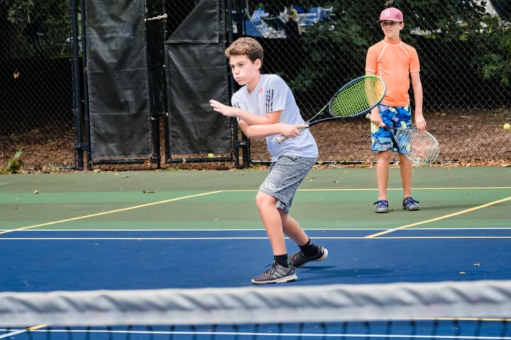 Boy playing tennis.