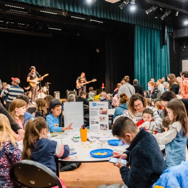 Kids doing a craft at a concert.