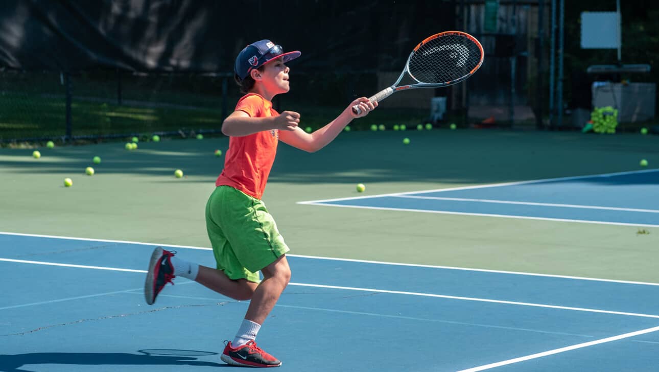 A boy playing tennis.