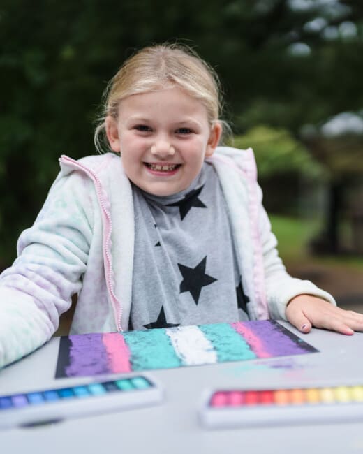 Girl doing a pastel craft.