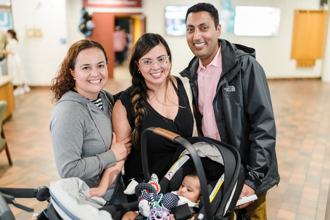 Family in the lobby of JCC Greater Boston with their newborn.