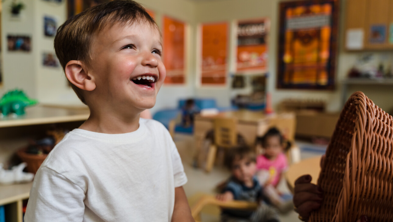 Kid smiling in the classroom.