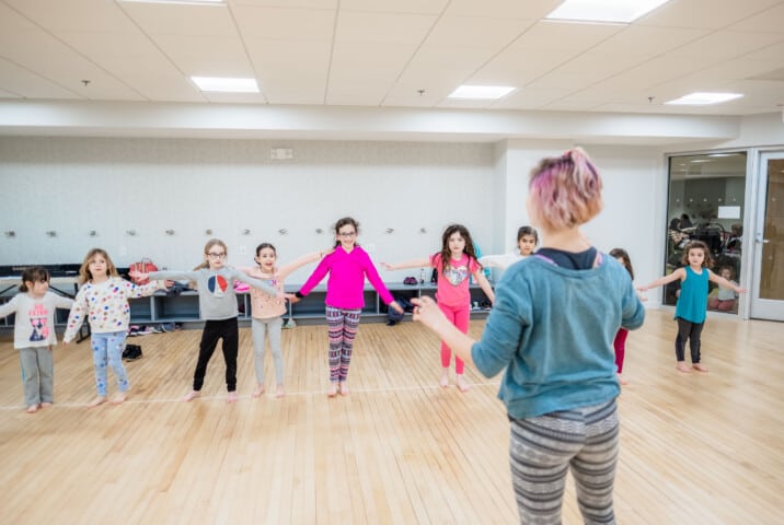 Kids taking a dance class.