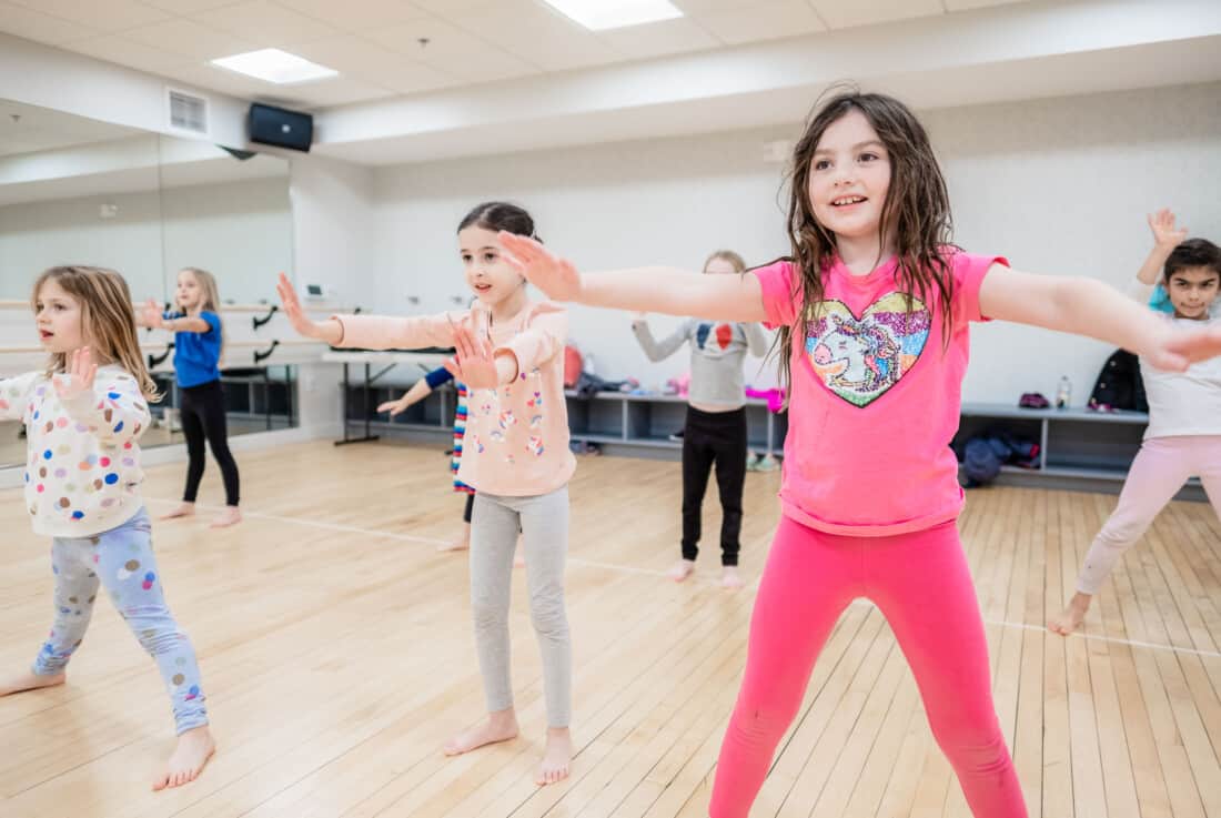 Kids taking a dance class.