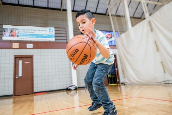 Boy dribbling a basketball.
