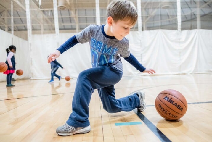 Boy dribbling a basketball.