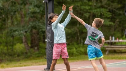 Kids playing basketball at Camp Grossman.