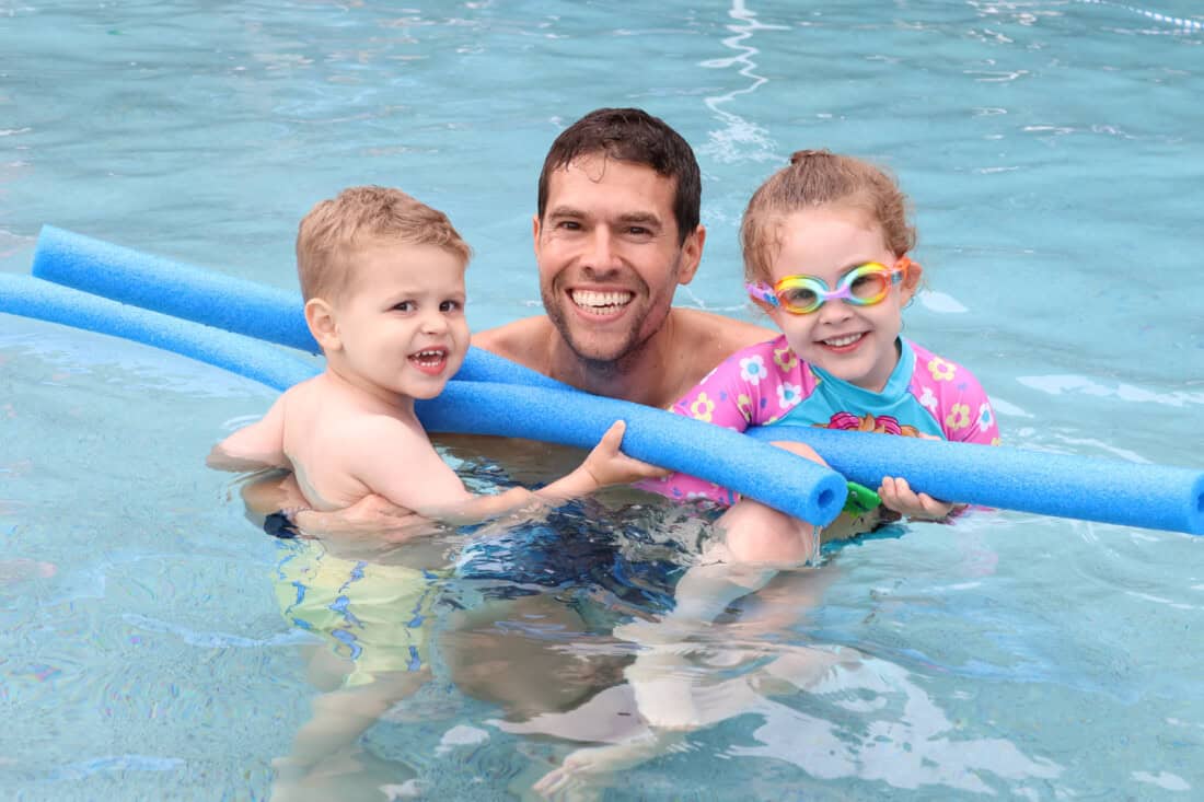 family enjoying the outdoor pool.
