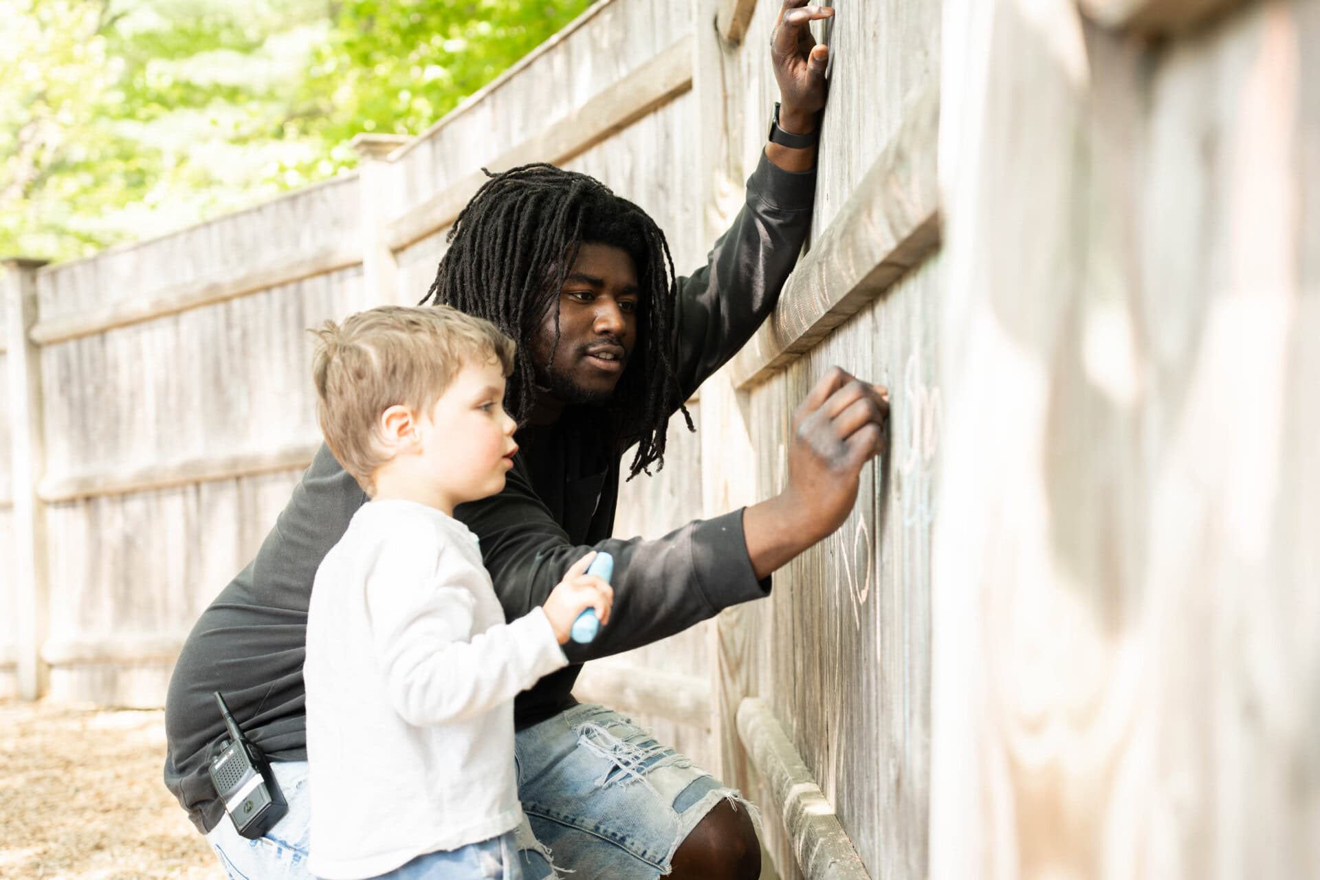 Child and teacher outside on the playground.