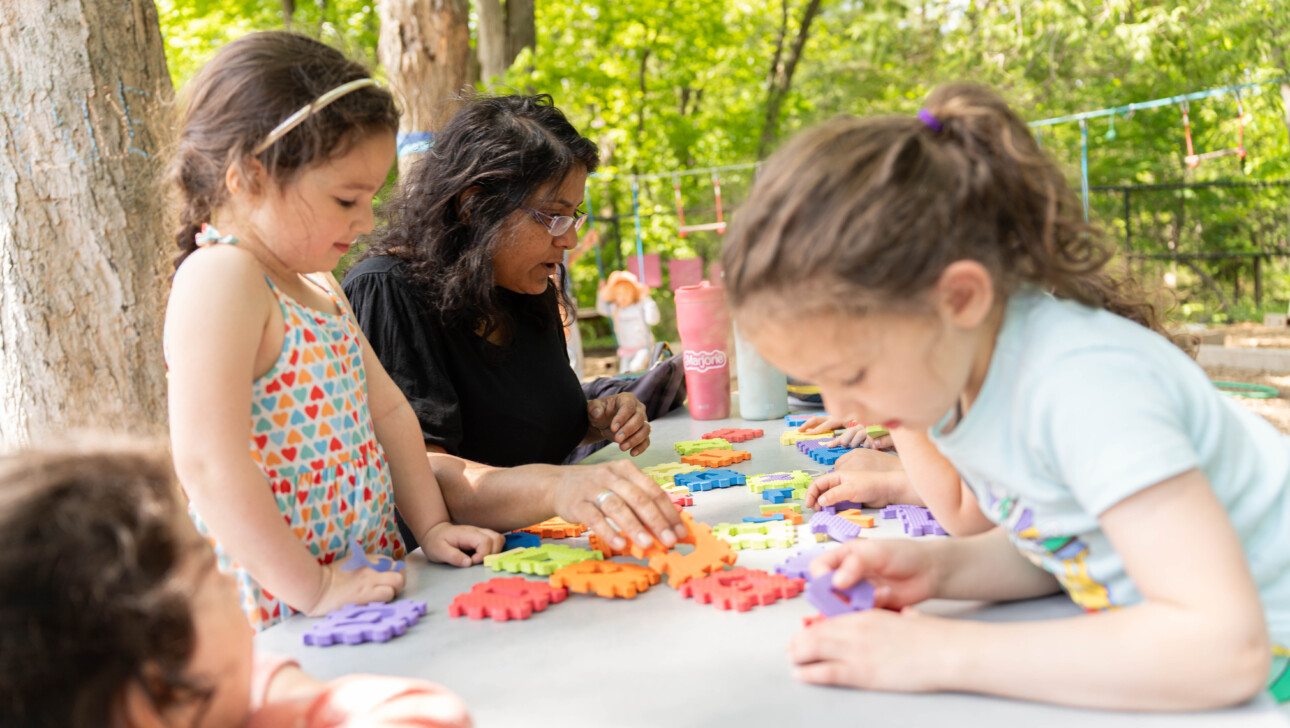 Children and teacher outside doing activities.