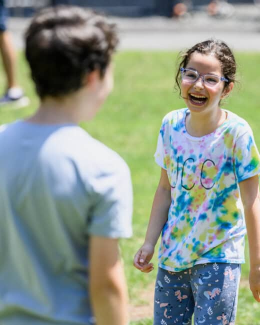 Girl smiling outside at camp.
