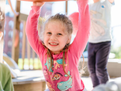 A young girl smiling.