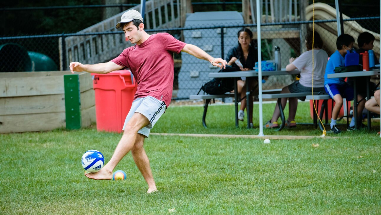 Man kicking around a soccer ball.