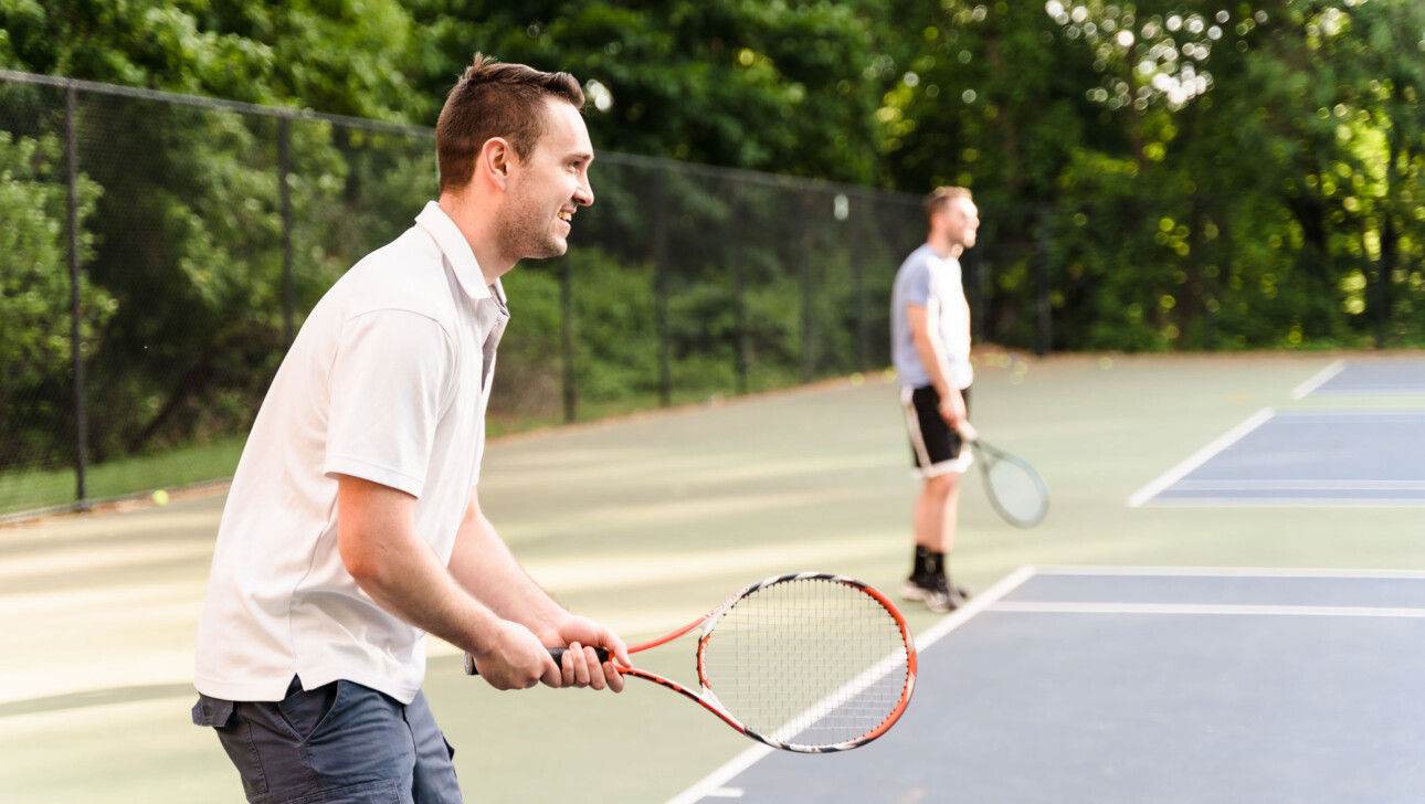 People playing tennis.