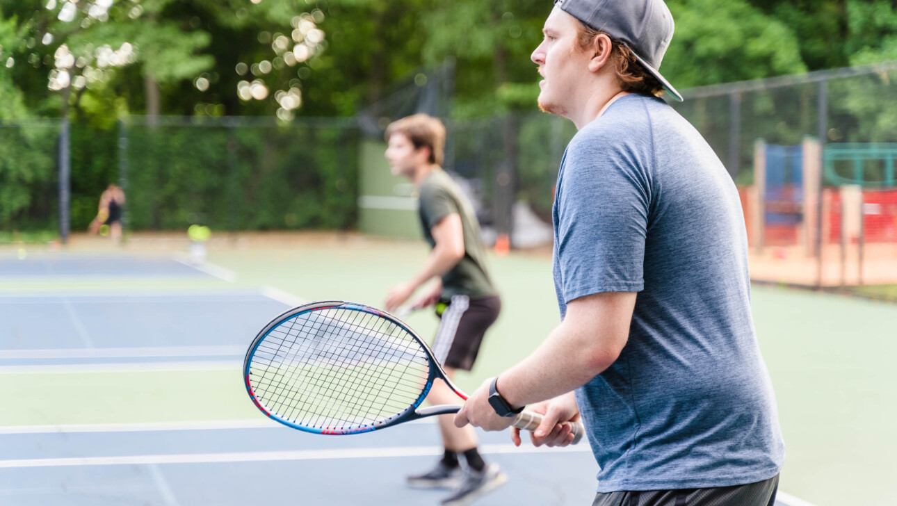 People playing tennis.