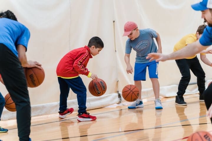 Two boys playing basketball.
