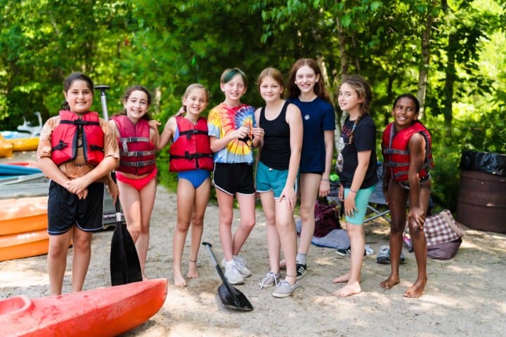 Girls smiling at the lakefront at Camp Grossman.