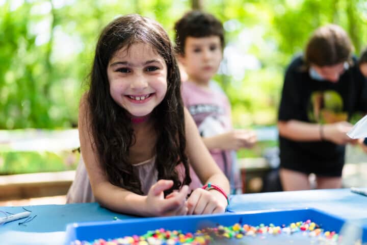 Girl doing arts and crafts at Camp Grossman.