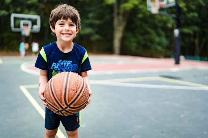 Boy holding a basketball.