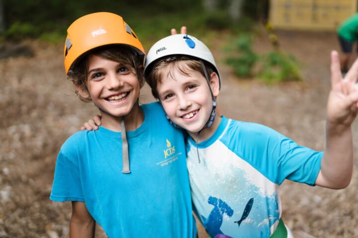 Boys smiling at the ropes course.