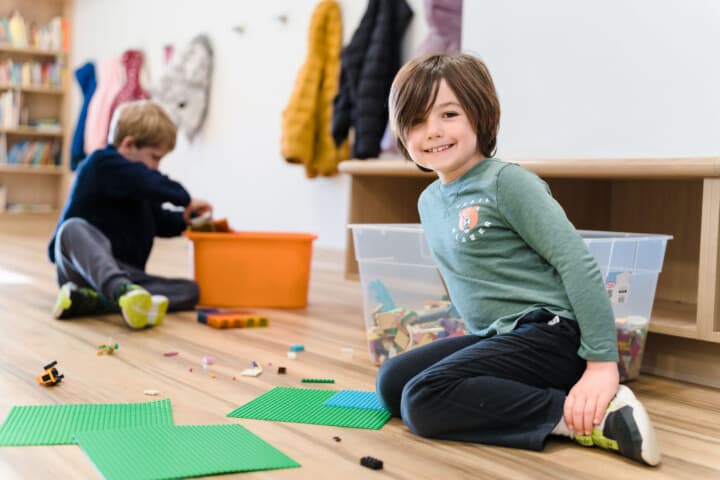 Boy playing lego on the floor.