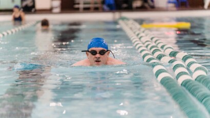 Man swimming laps in a pool.