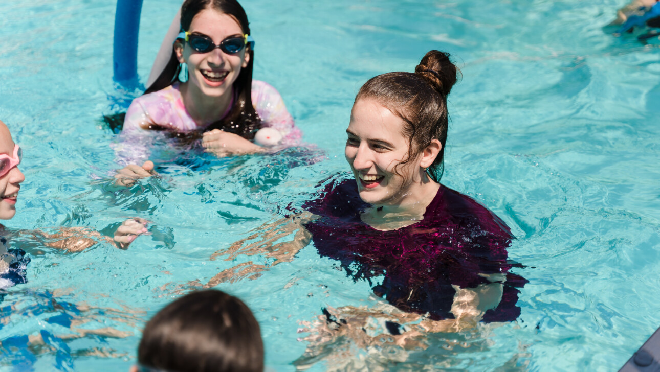 Girl smiling in a pool.