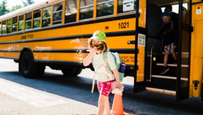 Girl getting off a bus.