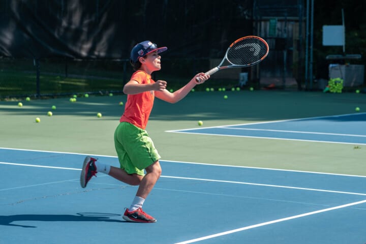 A boy playing tennis.
