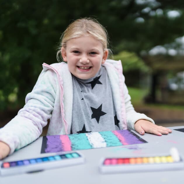 Girl doing a pastel craft.