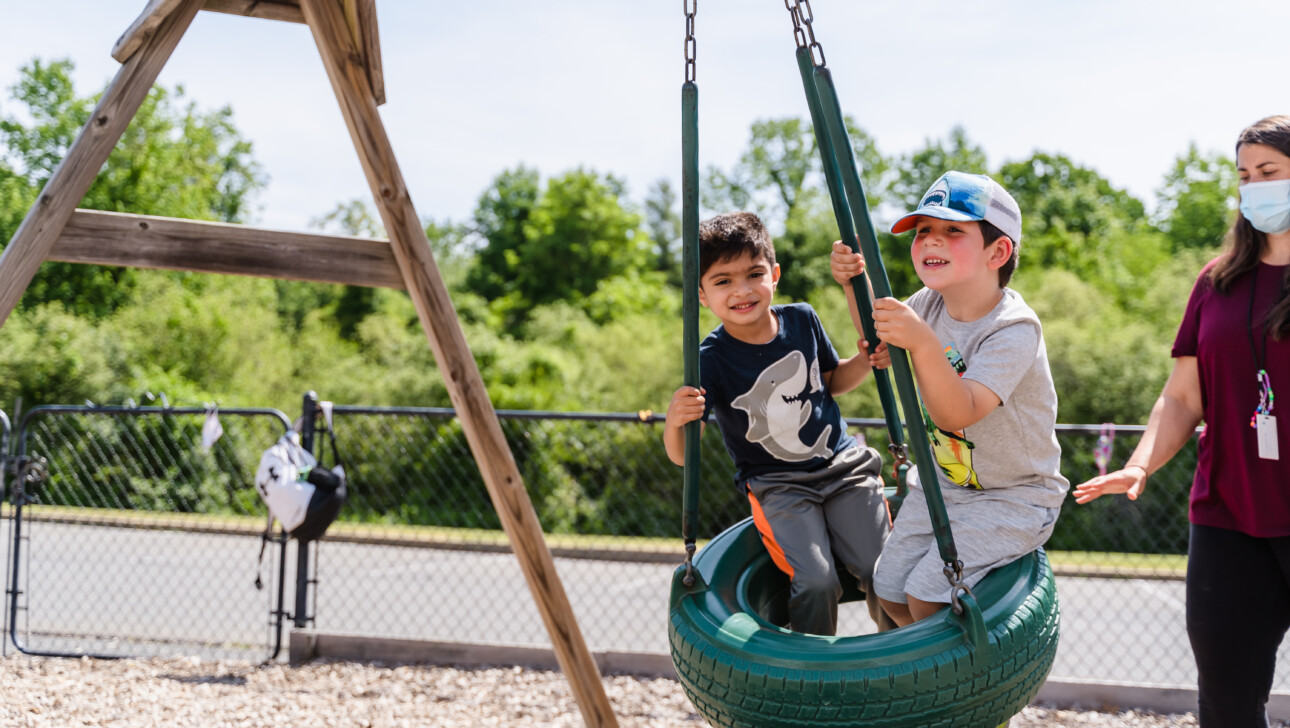 Kids swinging on the playground.
