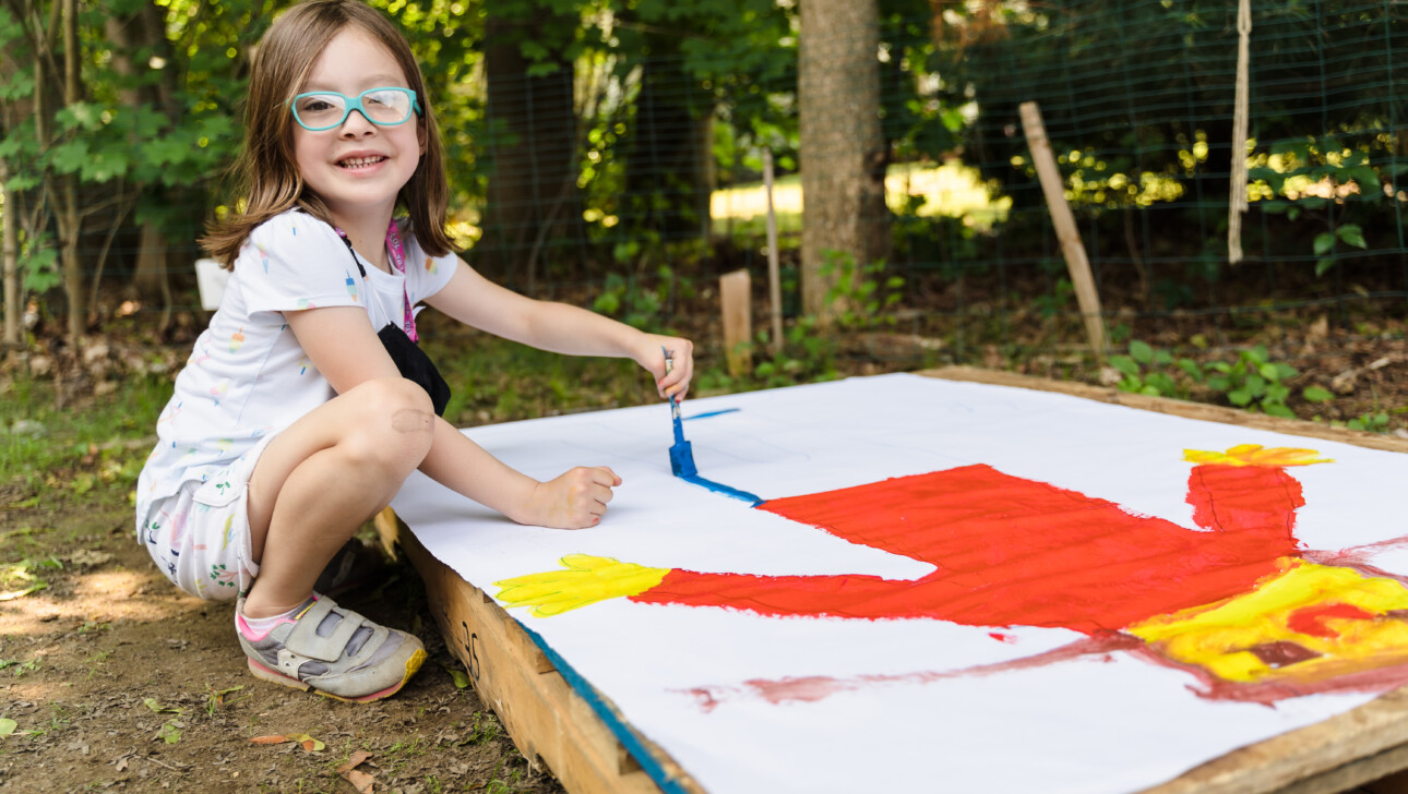 Girl painting a picture.