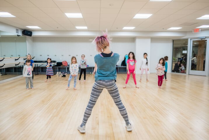 Kids taking a dance class.